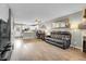 Bright living room with fireplace and wood floors seamlessly connects to the kitchen at 9615 W Chatfield Ave # C, Littleton, CO 80128