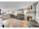 Bright living room with fireplace and wood floors seamlessly connects to the kitchen at 9615 W Chatfield Ave # C, Littleton, CO 80128
