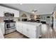 Open concept kitchen and living room with fireplace and stainless steel appliances at 9615 W Chatfield Ave # C, Littleton, CO 80128
