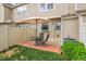 Private backyard patio with pavers, outdoor table, chairs, and shade, perfect for relaxing at 9615 W Chatfield Ave # C, Littleton, CO 80128