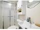 Compact bathroom with a glass-enclosed shower, sink, and mirrored cabinet at 4500 Zephyr St, Wheat Ridge, CO 80033
