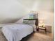 Bedroom with a bed, side table, and small window, creating a cozy sleeping space at 4500 Zephyr St, Wheat Ridge, CO 80033