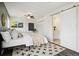 A cozy bedroom featuring a barn door to the bathroom and bright natural light at 4500 Zephyr St, Wheat Ridge, CO 80033