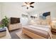 A staged bedroom with a TV and decor to help envision your ideal living space at 4500 Zephyr St, Wheat Ridge, CO 80033