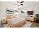 Bright bedroom featuring a ceiling fan, two windows, and neutral decor at 4500 Zephyr St, Wheat Ridge, CO 80033