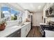 Bright kitchen featuring white cabinetry, stainless steel appliances, and a large window at 4500 Zephyr St, Wheat Ridge, CO 80033
