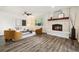 Cozy living room with a decorative fireplace, wood floors, and modern furnishings at 4500 Zephyr St, Wheat Ridge, CO 80033