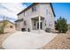 Spacious backyard with concrete patio, grass, and gravel at 2516 Mountain Sky Dr, Castle Rock, CO 80104