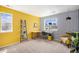 Bright bedroom featuring multiple windows providing neighborhood views and unique geometric wallpaper design at 2516 Mountain Sky Dr, Castle Rock, CO 80104