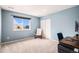 Light-filled bedroom with a large window, closet, and blue accent walls at 2516 Mountain Sky Dr, Castle Rock, CO 80104