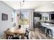 Dining area with backyard views, a modern light fixture, and an adjacent kitchen at 2516 Mountain Sky Dr, Castle Rock, CO 80104