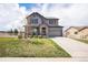 Inviting two-story home with a covered porch, red shutters, and a well-maintained front lawn at 2516 Mountain Sky Dr, Castle Rock, CO 80104