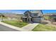 Charming two-story home with a well-manicured lawn, inviting front porch, and an attached two-car garage at 2516 Mountain Sky Dr, Castle Rock, CO 80104