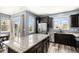 Open-concept kitchen with stainless steel appliances, granite countertops, and a breakfast bar at 2516 Mountain Sky Dr, Castle Rock, CO 80104
