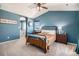 Bright main bedroom featuring vaulted ceilings, ensuite bathroom, and a decorative wrought iron bed frame at 2516 Mountain Sky Dr, Castle Rock, CO 80104