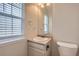 Modest bathroom features window, vanity, sink, and toilet at 1639 S Ivory Cir # C, Aurora, CO 80017