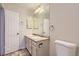 Bathroom with double sink vanity, mirror, and toilet at 1639 S Ivory Cir # C, Aurora, CO 80017