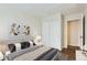 Bedroom features closet, decor, and view of hall with hardwood floor at 1639 S Ivory Cir # C, Aurora, CO 80017