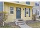 Home facade features a blue front door with a window and shrubs at 1639 S Ivory Cir # C, Aurora, CO 80017