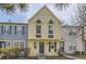Charming two-story townhouse with yellow siding, gray accents, and well-maintained landscaping at 1639 S Ivory Cir # C, Aurora, CO 80017