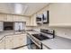 Updated kitchen featuring stainless steel appliances, stone countertops, and ample cabinet space at 1639 S Ivory Cir # C, Aurora, CO 80017