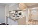 Open kitchen with a breakfast bar, stainless appliances, and easy access to the stairs and front entrance at 1639 S Ivory Cir # C, Aurora, CO 80017