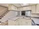 Well-lit kitchen with sleek countertops, a convenient breakfast bar, and easy access to the living area at 1639 S Ivory Cir # C, Aurora, CO 80017
