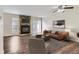 Inviting living room featuring a stone fireplace, ceiling fan, and access to the backyard at 1639 S Ivory Cir # C, Aurora, CO 80017