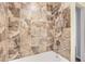 Tiled bathroom shower with adjustable shower head and white tub at 1639 S Ivory Cir # C, Aurora, CO 80017