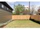 Spacious fenced backyard with lush green grass, new landscaping, and space to entertain at 1680 S Humboldt St, Denver, CO 80210