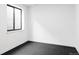 A room in a basement featuring black rubber flooring and a window at 1680 S Humboldt St, Denver, CO 80210