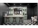 Basement bar area featuring a black and white tile floor and stylish counter seating at 1680 S Humboldt St, Denver, CO 80210