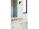 Bright bathroom vanity featuring a stone countertop, white cabinetry and modern fixtures at 1680 S Humboldt St, Denver, CO 80210