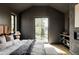 Modern main bedroom featuring dark gray walls, light wood flooring, and a view of the backyard at 1680 S Humboldt St, Denver, CO 80210