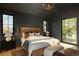 Modern main bedroom featuring dark gray walls, light wood flooring, and oversized windows at 1680 S Humboldt St, Denver, CO 80210