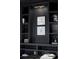 Elegant built-in shelving unit with dark paint, recessed lighting, and decorative elements at 1680 S Humboldt St, Denver, CO 80210
