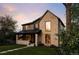 Charming two-story home showcasing brick, dark siding, and lush green lawn with sidewalk pathway at 1680 S Humboldt St, Denver, CO 80210