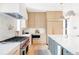 Modern kitchen featuring stainless steel appliances, custom cabinetry, and a spacious island at 1680 S Humboldt St, Denver, CO 80210
