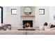 Cozy living room featuring a fireplace with a wooden mantel and a striking round mirror above at 1680 S Humboldt St, Denver, CO 80210