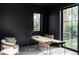 Modern office space with black walls, large windows, and a stylish desk setup at 1680 S Humboldt St, Denver, CO 80210