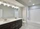 Bright bathroom featuring double vanity, tiled shower/tub, and modern finishes for comfortable living at 17569 Cerberus Ct, Monument, CO 80132