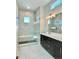 Sleek bathroom featuring tiled walk-in shower, and double sink vanity for modern, luxurious living at 17569 Cerberus Ct, Monument, CO 80132