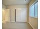 Bright bedroom features neutral walls, carpet, closet with white sliding doors and window at 17569 Cerberus Ct, Monument, CO 80132