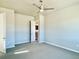 Bright and airy bedroom with neutral walls and carpet, with a door open to the house at 17569 Cerberus Ct, Monument, CO 80132