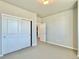 Bright bedroom features neutral walls, carpet, and closet with white sliding doors at 17569 Cerberus Ct, Monument, CO 80132