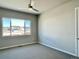 Spacious bedroom with ceiling fan, large window, and neutral tones for comfortable living at 17569 Cerberus Ct, Monument, CO 80132