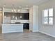 Bright, open kitchen with a large island, stainless appliances, and dark cabinetry at 17569 Cerberus Ct, Monument, CO 80132