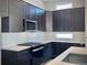 Well-lit kitchen featuring stainless steel appliances, dark cabinetry, and white subway tile at 17569 Cerberus Ct, Monument, CO 80132
