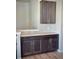 Wall cabinets and countertop with dark wood cabinets and quartz counters at 17569 Cerberus Ct, Monument, CO 80132