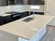 Close-up of a large kitchen island with a stainless steel sink and modern faucet at 17569 Cerberus Ct, Monument, CO 80132